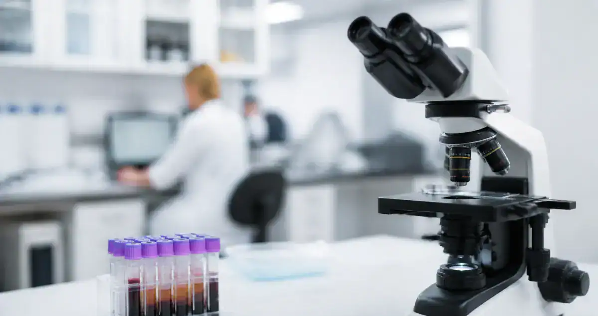 Pathology lab microscope and sample tubes showing diagnostic process without needing patient slides for consultation