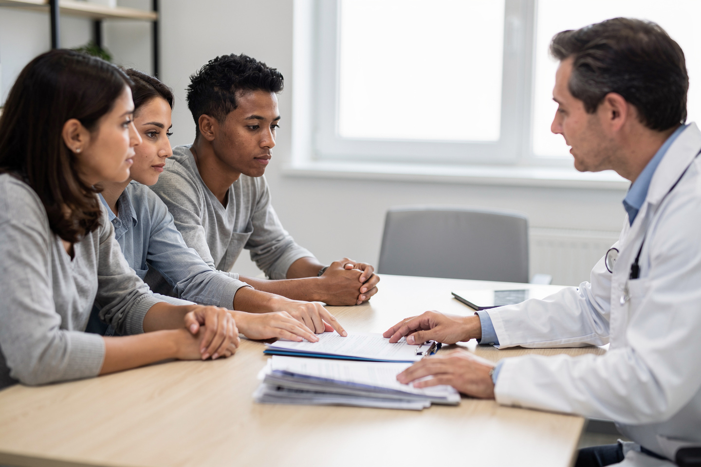 A family reviewing paperwork while learning about Autopsy Toxicology Findings.