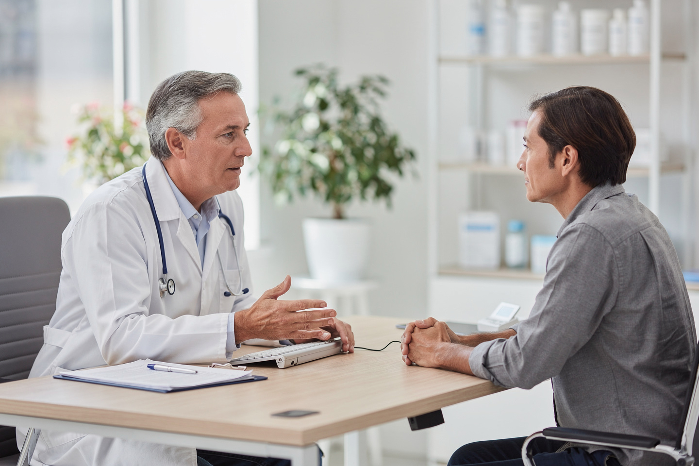 A doctor discusses pathologist consultation questions with a patient in a calm office setting.