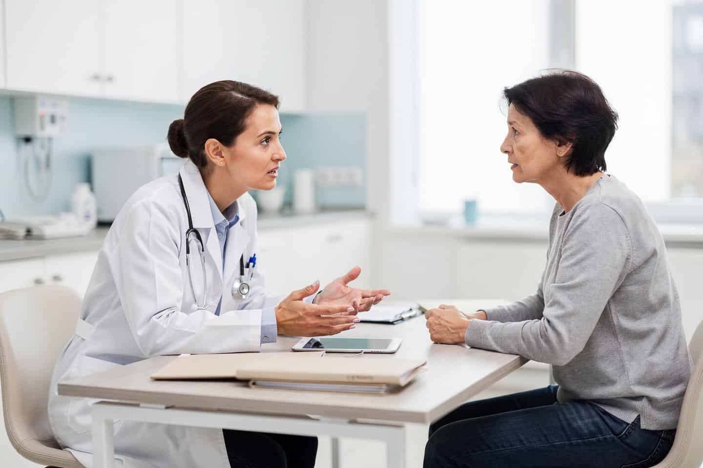 A doctor calmly explains how to choose a Pathology Consultation Expert to a worried patient.