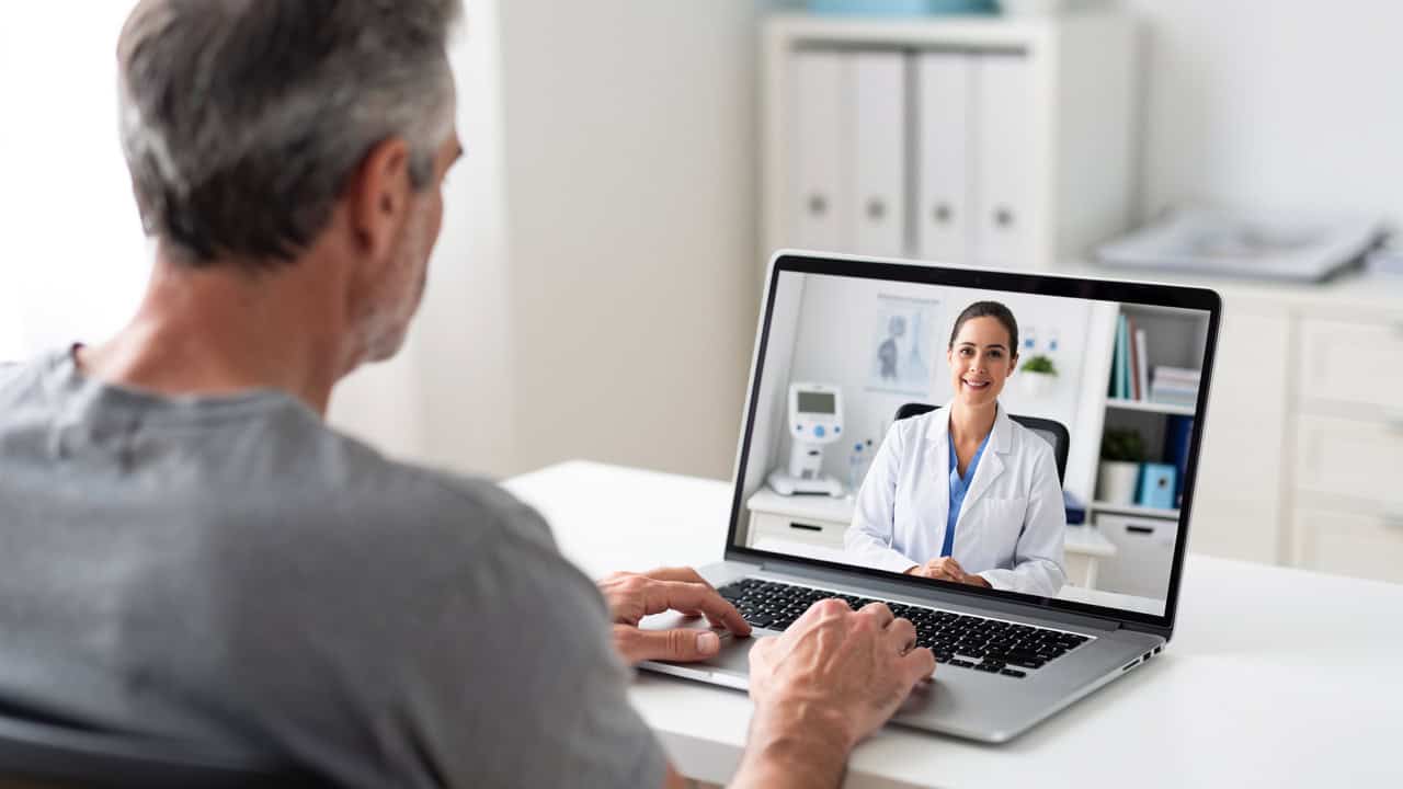 A patient discusses questions with a Pathology second opinion specialist during a telemedicine visit.