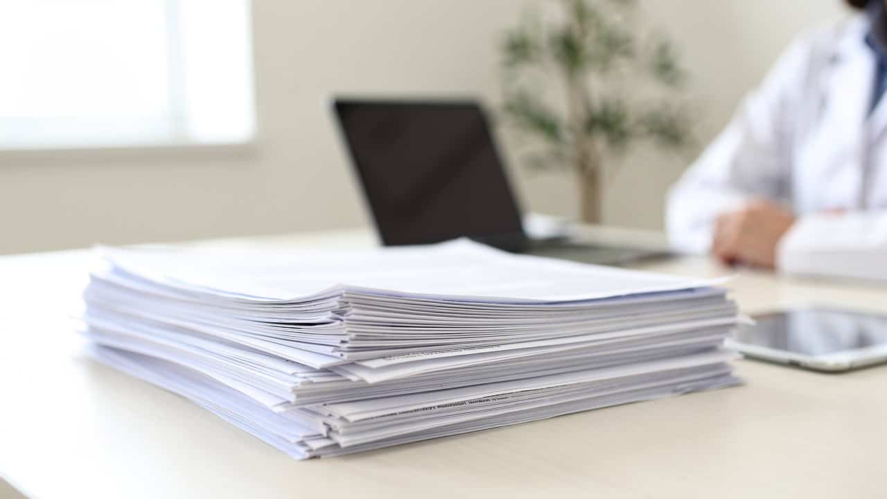 Medical records are organized on a desk for a Second opinion request and pathology review.