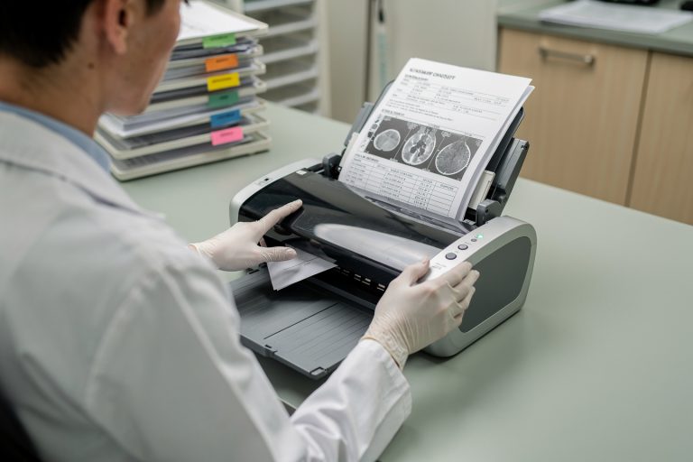 Medical records being scanned for a pathology second opinion to help improve treatment outcomes.