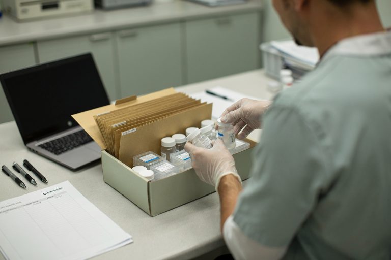 Medical records and biopsy materials being packed for a pathology consultation before starting treatment