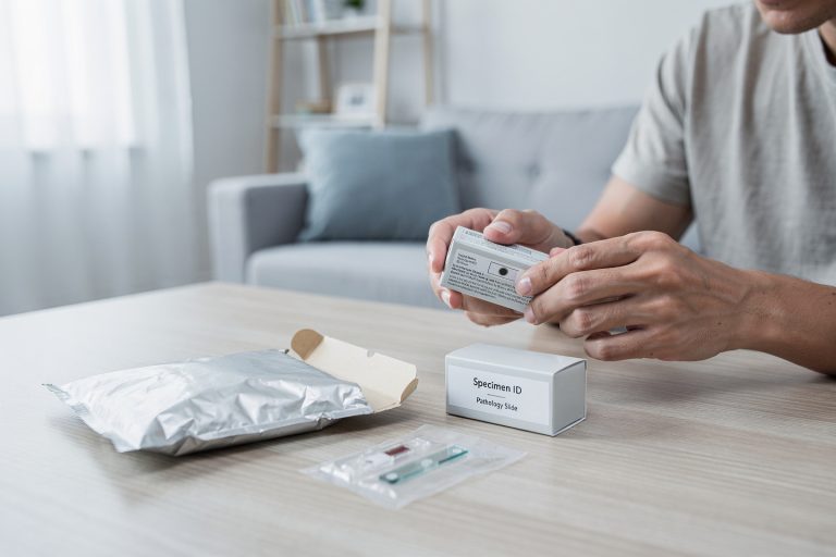 A person at home opening a mailed pathology slide package for a pathology slides second opinion sample sharing process