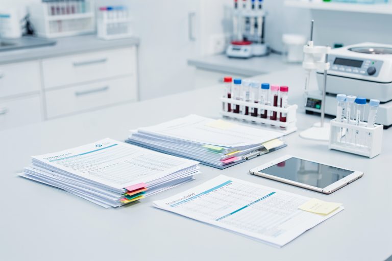 Empty lab bench with pathology reports representing next steps after a second opinion disagreement.