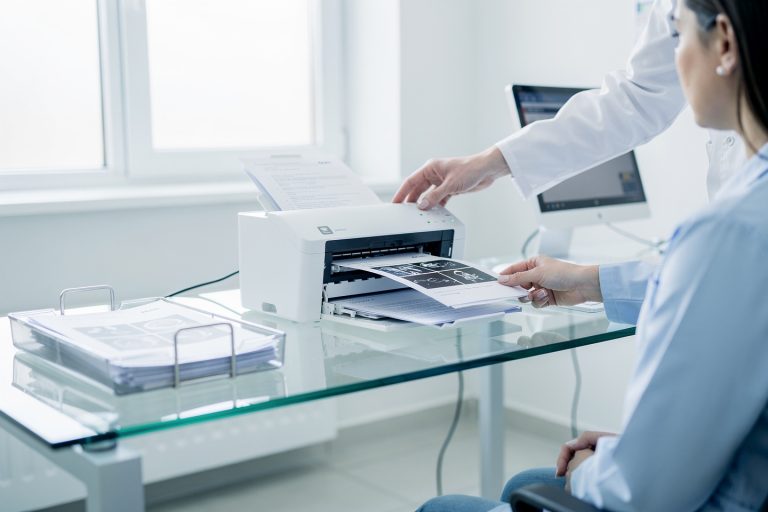 Medical records being scanned as part of a consultation that may change treatment decisions after a second opinion.