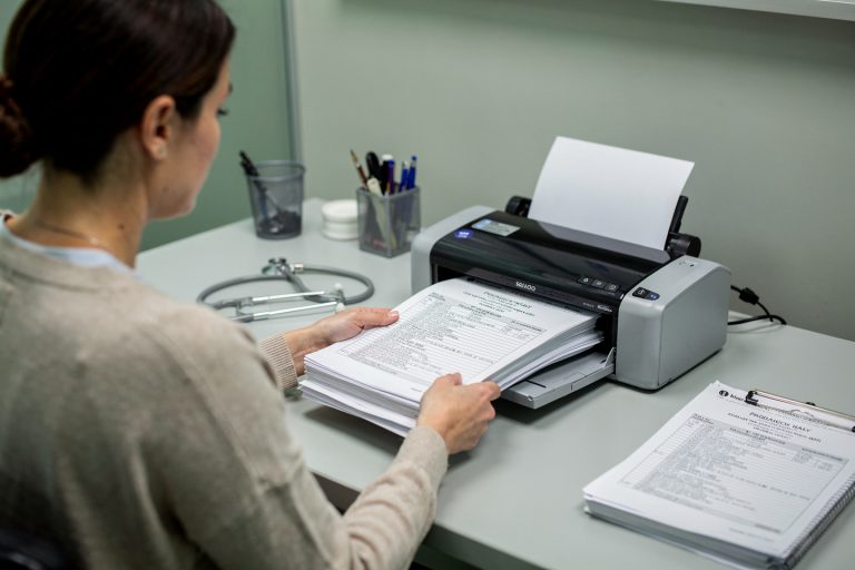 Medical records being scanned for a second pathology opinion report review.